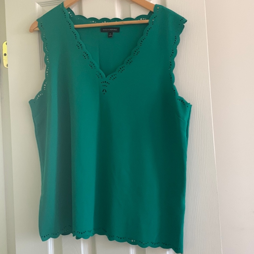 A green top with floral cut work